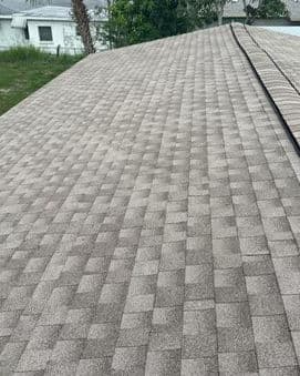 Overhead view of a textured asphalt shingle roof on a residential building.